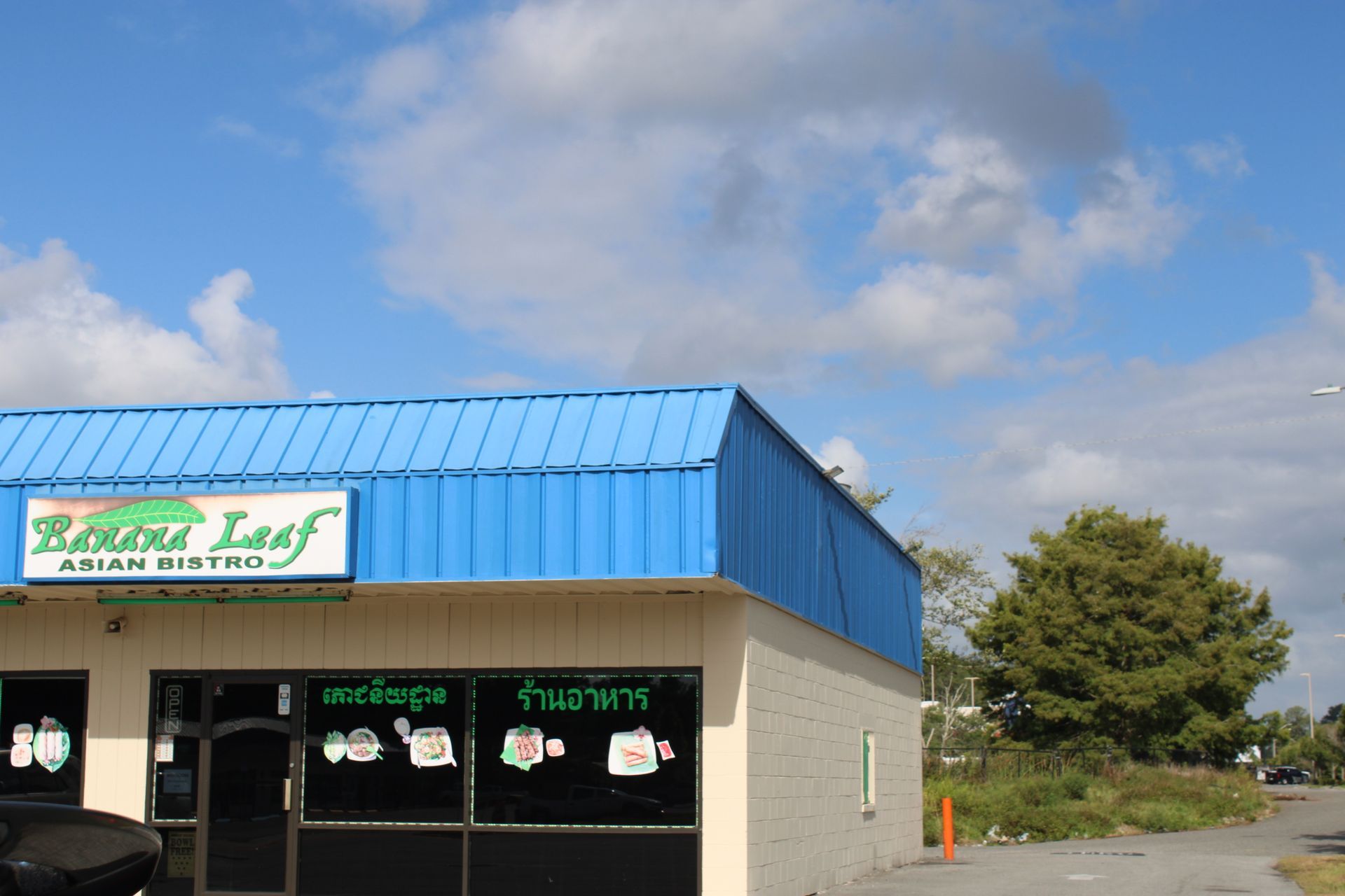 A building with a blue roof and a sign that says banana leaf