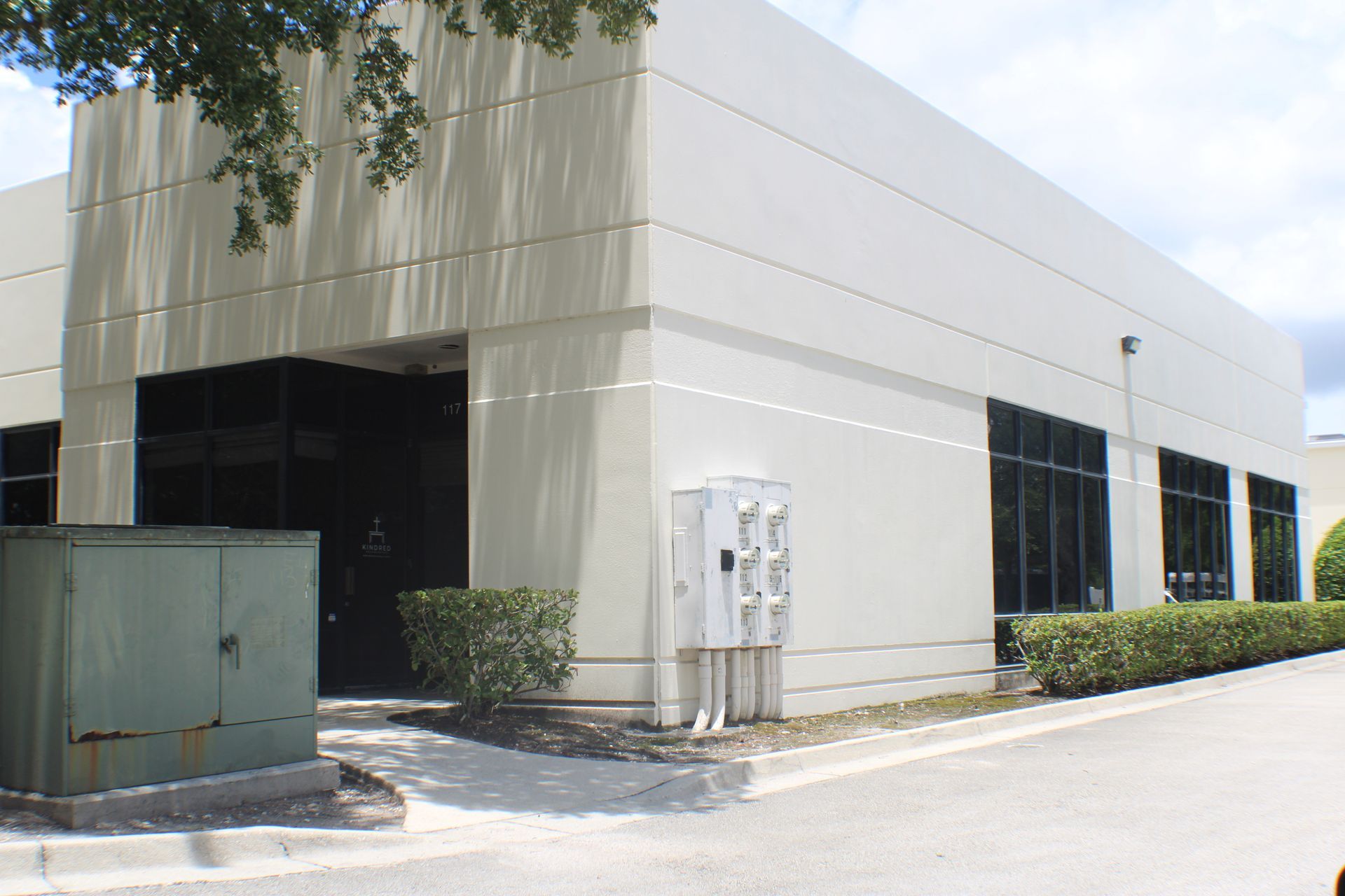 An aerial view of a building with a lake in the background