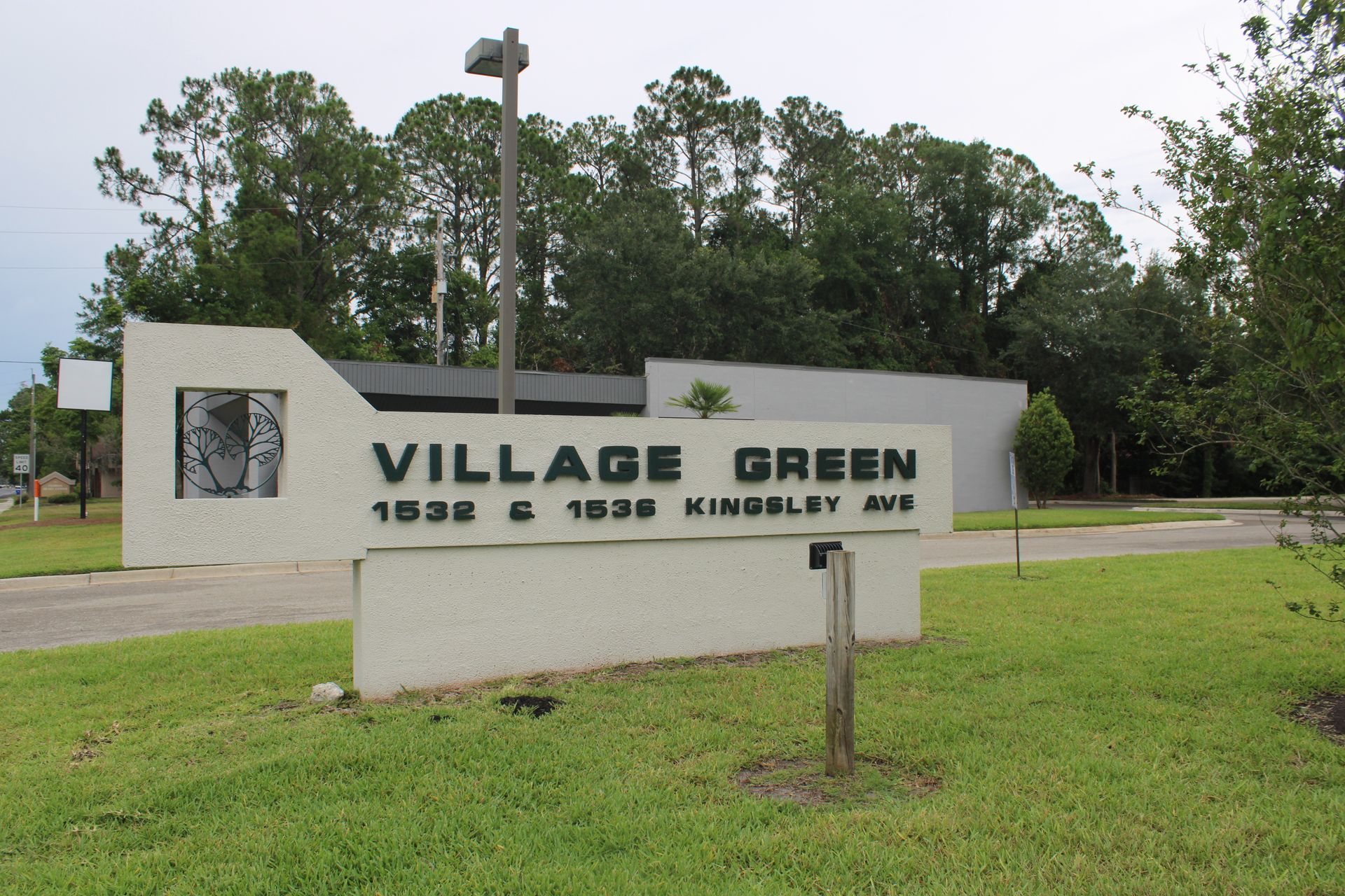 A sign that says village green on it