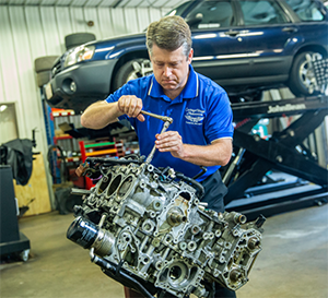 Staff Member Performing Repairs on Engine | Carriage House Automotive