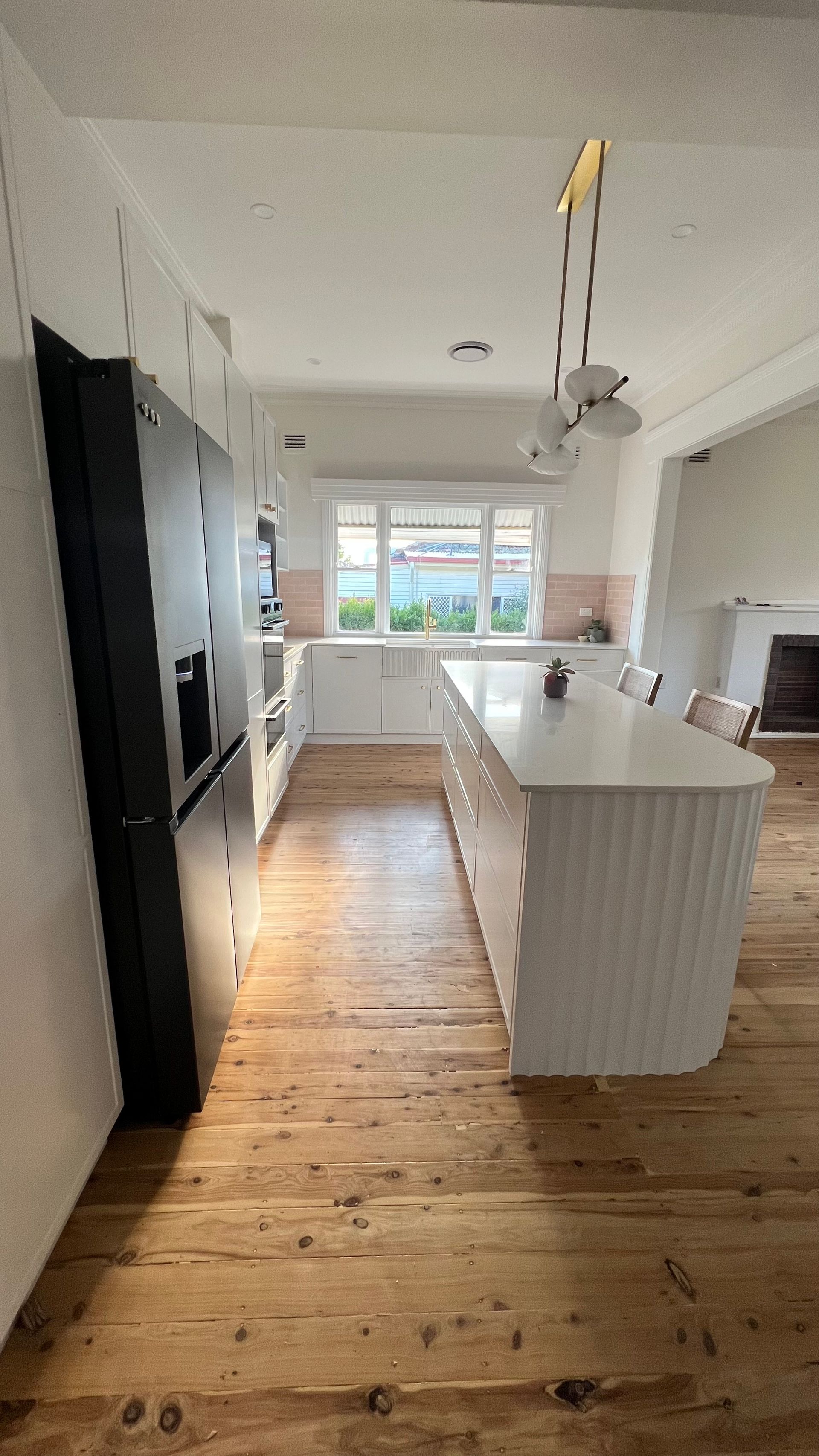 A Large Wooden Deck With A White Railing In Front Of A House — Hamilton Building And Construction Pty Ltd In Gobbagombalin, NSW