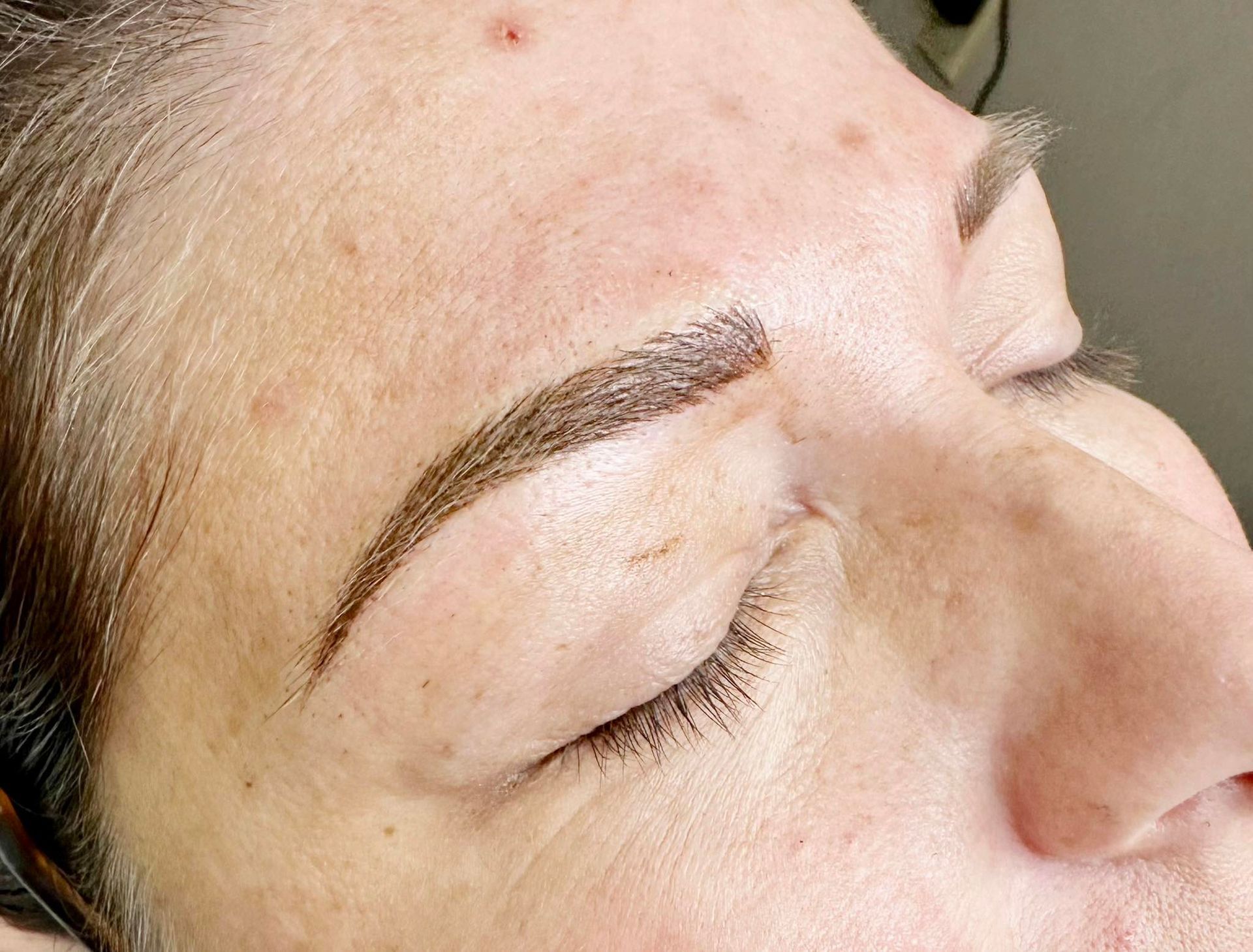 A close up of a woman 's nails with purple glitter and rhinestones