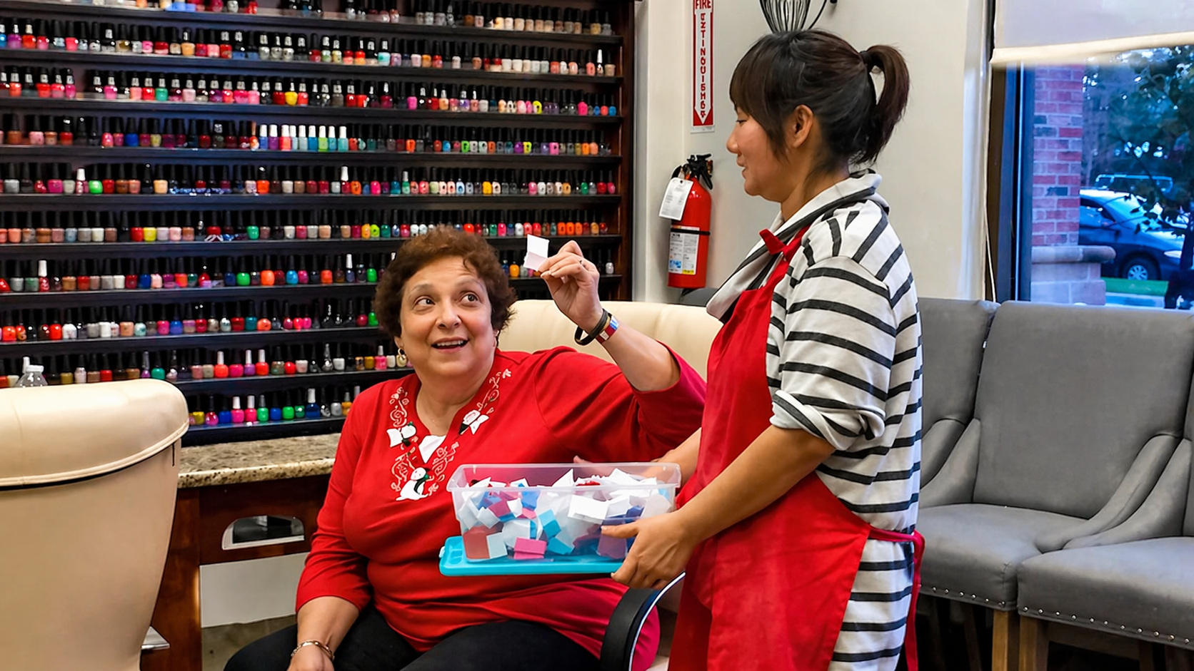 A shelf filled with bottles of nail polish of different colors.