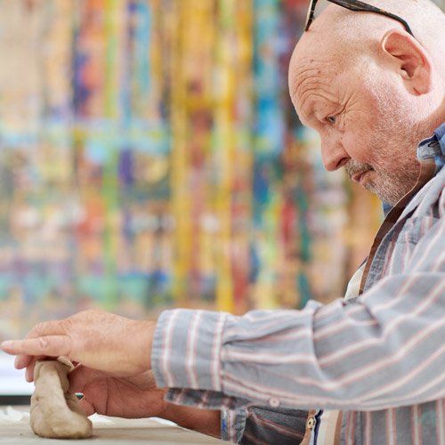 Älterer Mann gestaltet mit Ton