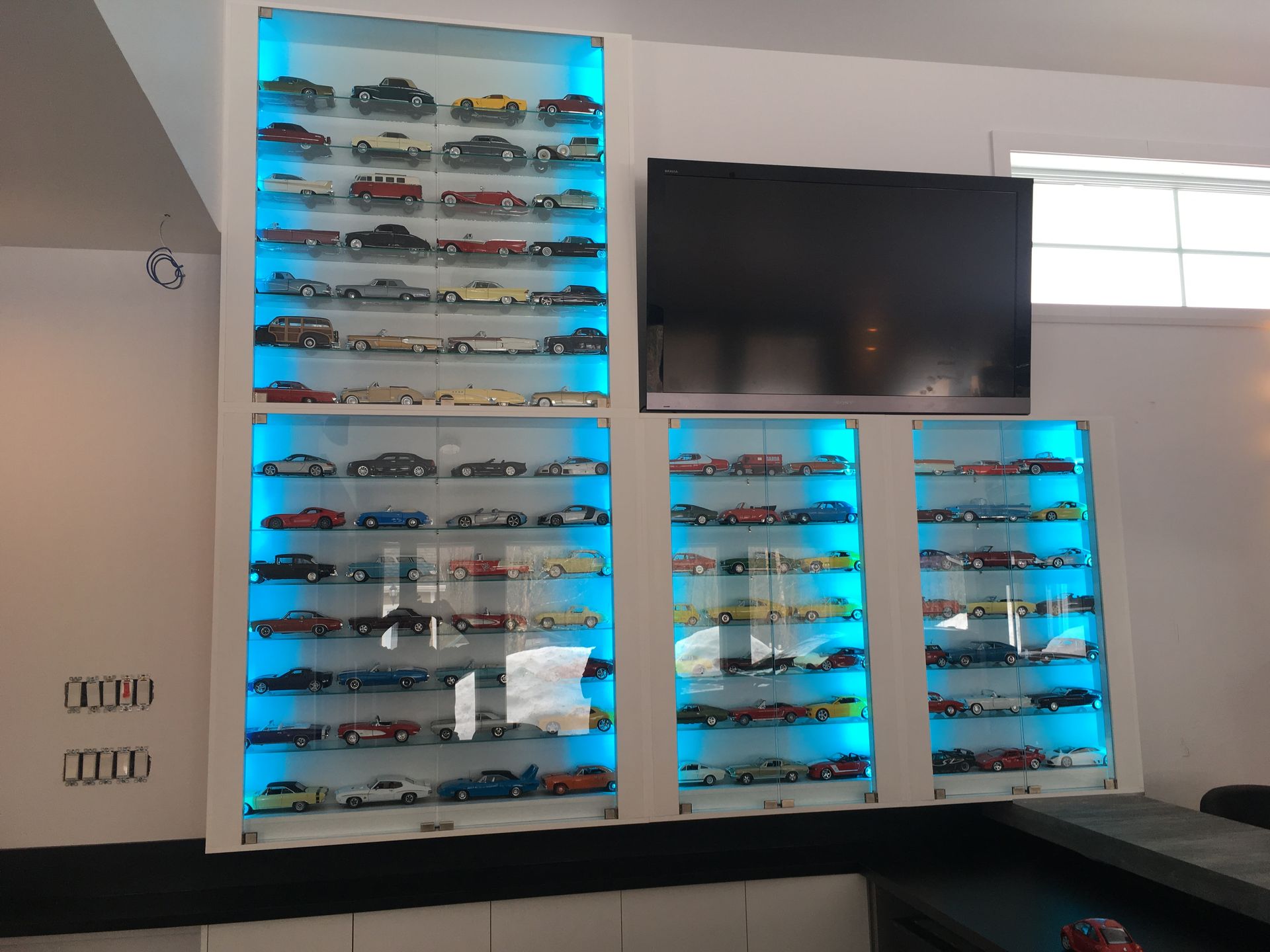 Un mur avec beaucoup de petites voitures dessus