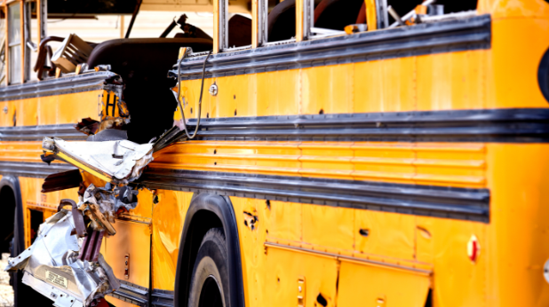 a yellow school bus that has been damaged in an accident