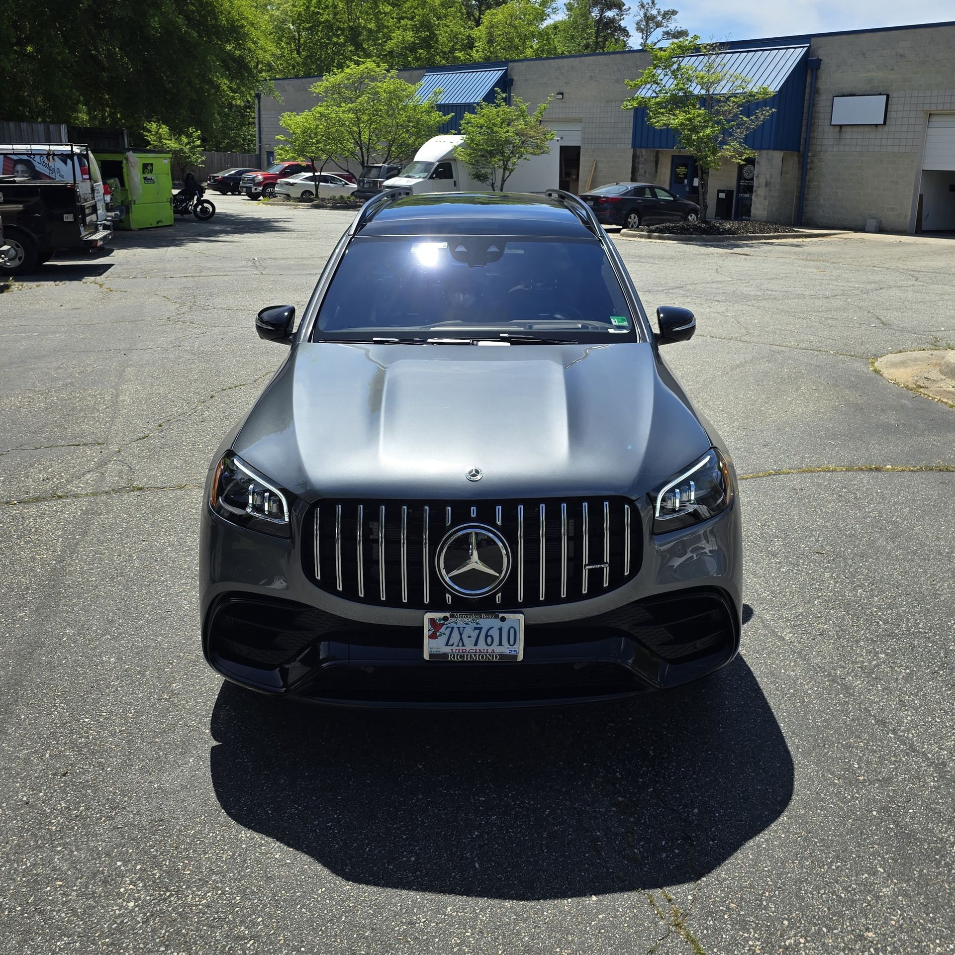 Gray Mercedes-Benz SUV with black accents parked on asphalt. Shiny front, facing the viewer.