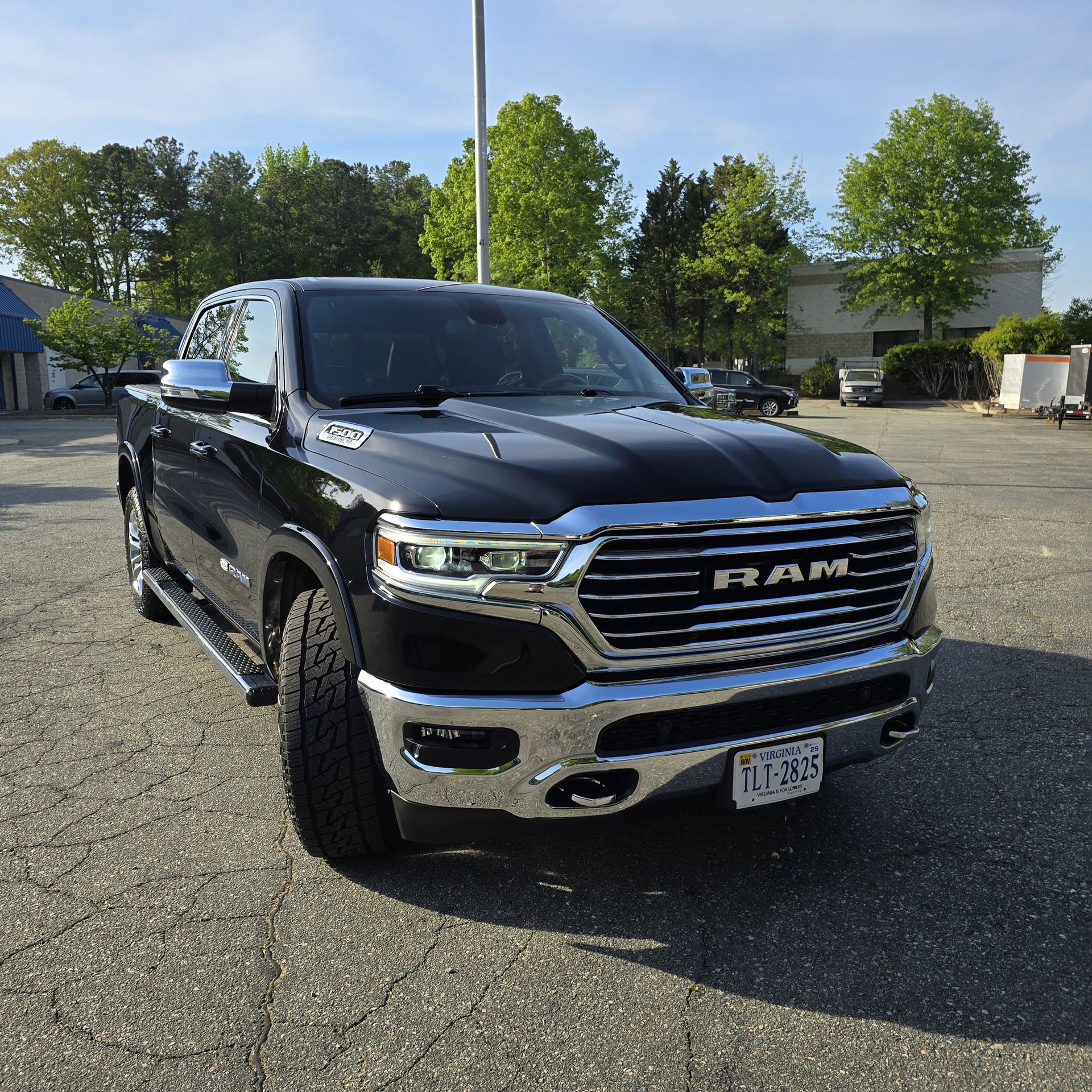 Black Ram pickup truck parked outside on a sunny day.