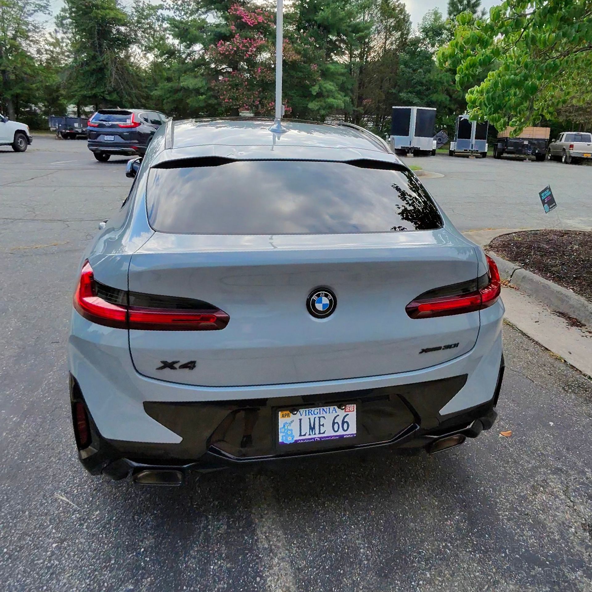 Gray BMW X4 SUV in a parking lot with tinted windows and black accents.