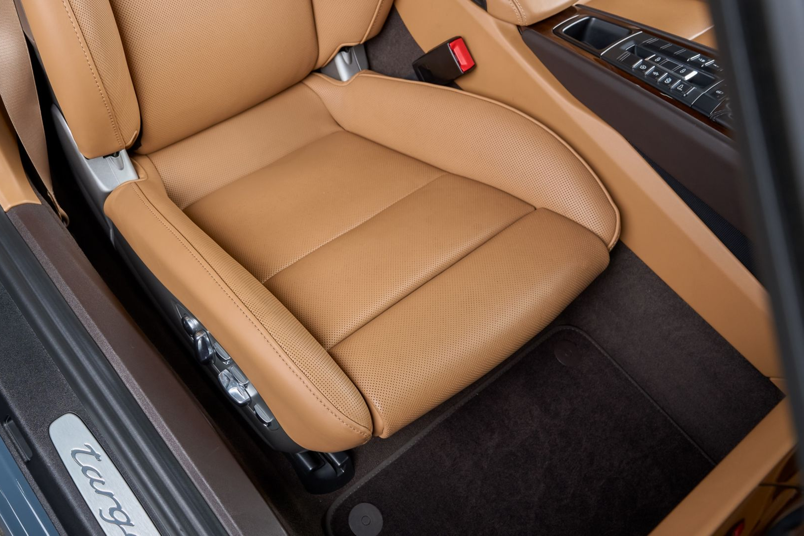 A man is washing a black car with a glove .