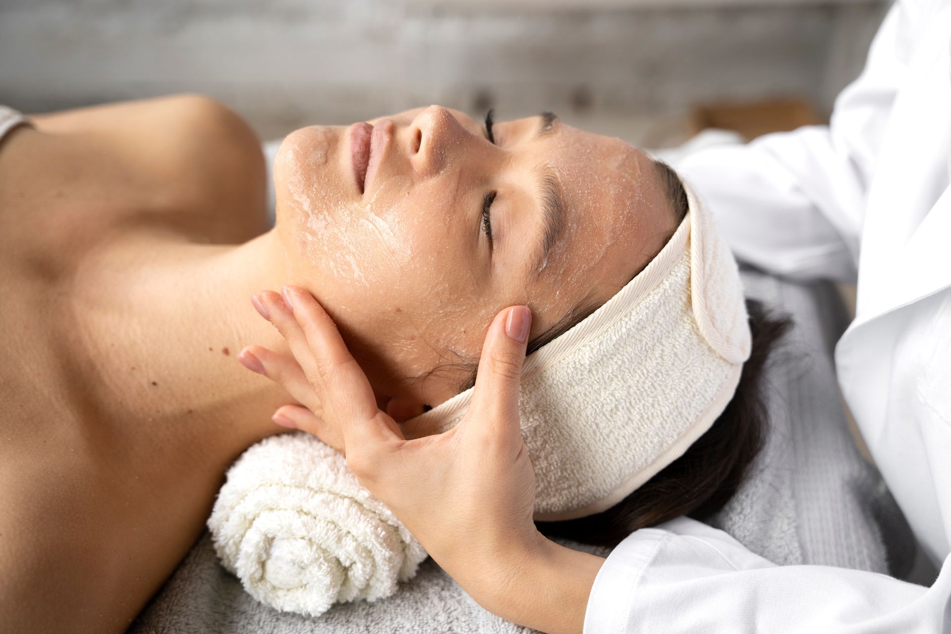 A woman is getting a facial treatment at a spa.
