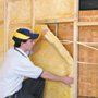 man installing wall insulation
