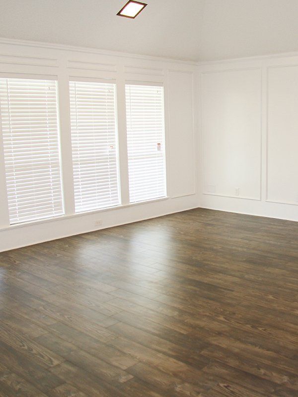 Empty Room With Window And Wooden Floor — Timber Flooring in Lismore, NSW