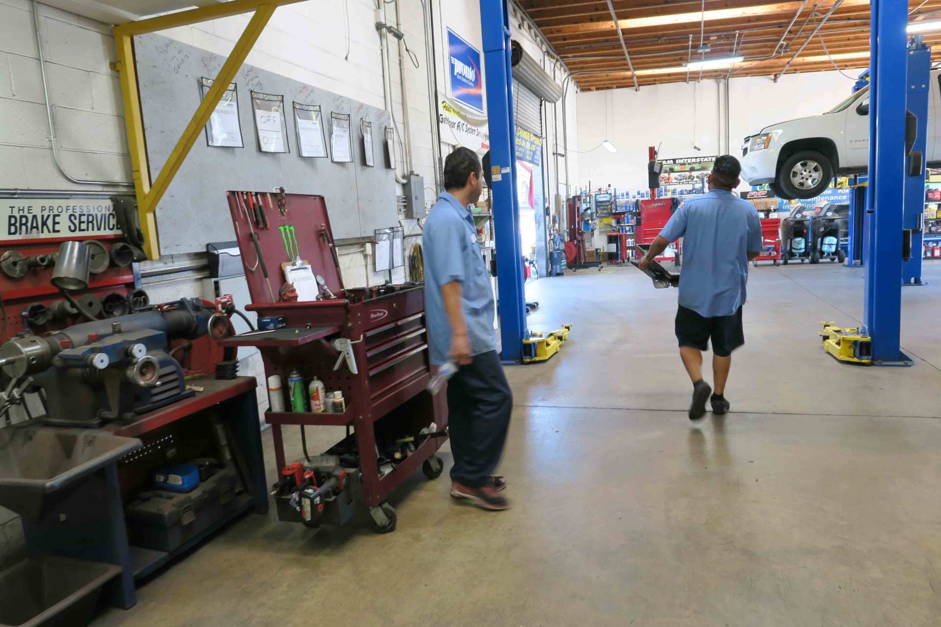 Emission Testing — Employee Carrying Car Part in Ontario, California