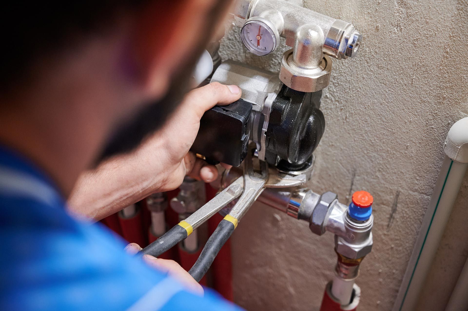 A worker is installing a pump.