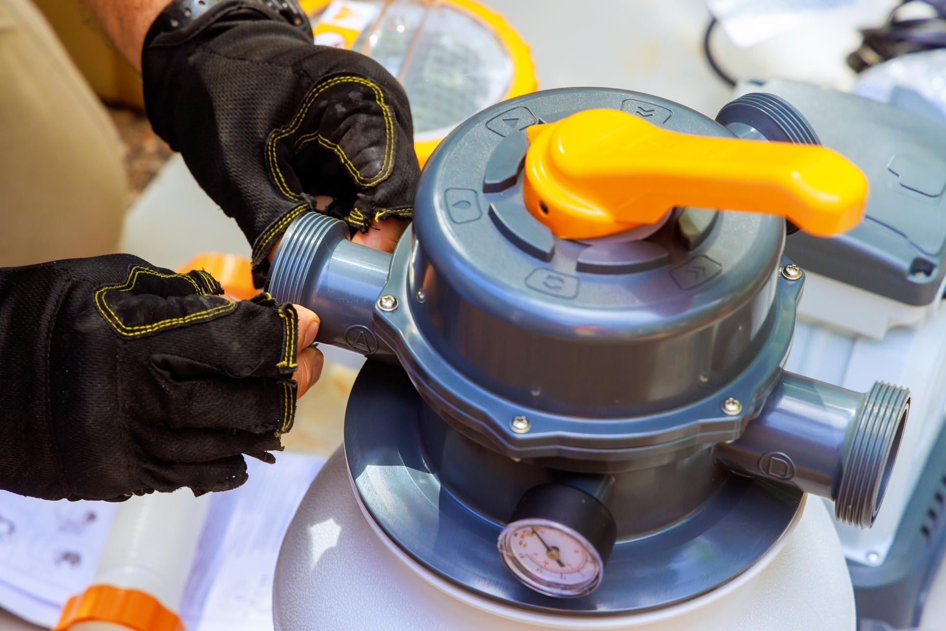A maintenance worker assembles a filter system tank equipment.