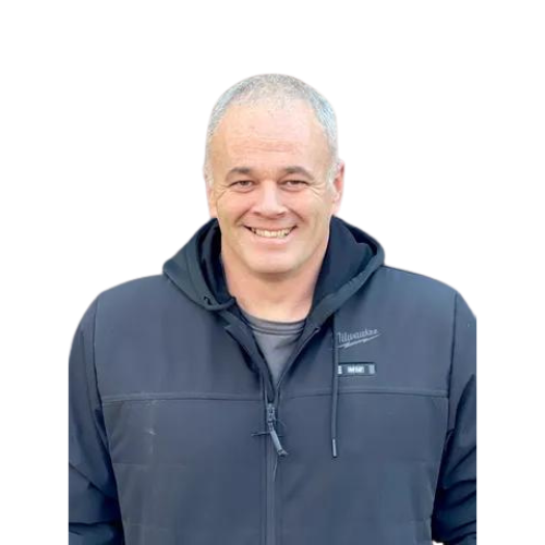 A man is wearing a black jacket with a hood and smiling.