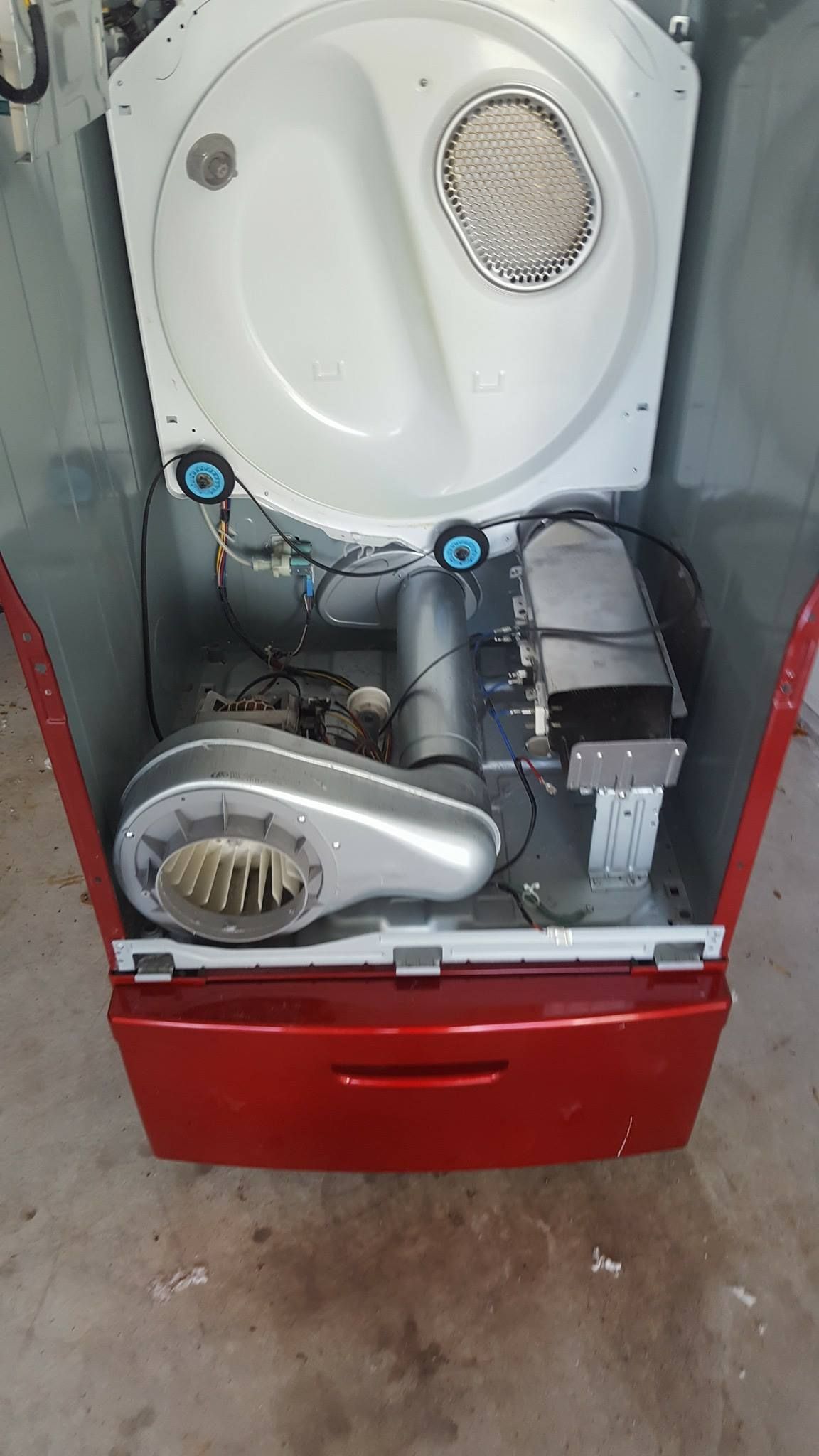 The inside of a red dryer with the door open.