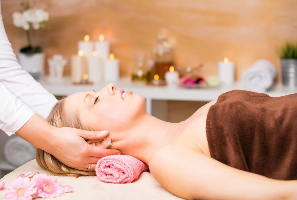 A Woman Is Getting a Massage at A Spa — Brow & Lash Clinic In Cairns

