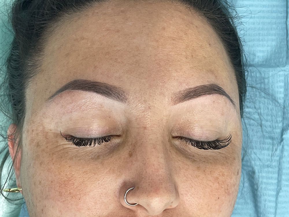 A Close up Of a Woman's Face with Her Eyes Closed and A Nose Ring — Brow & Lash Clinic In Cairns