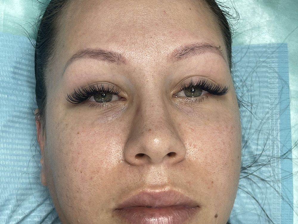 A Close up Of a Woman's Face with Long Eyelashes — Brow & Lash Clinic In Cairns