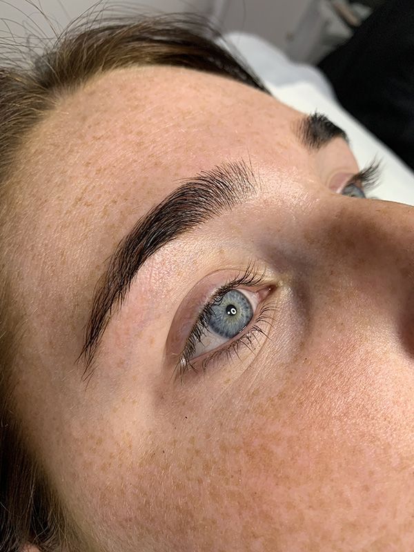 Woman's Face with Blue Eyes After Eyebrow Procedure — Brow & Lash Clinic In Cairns