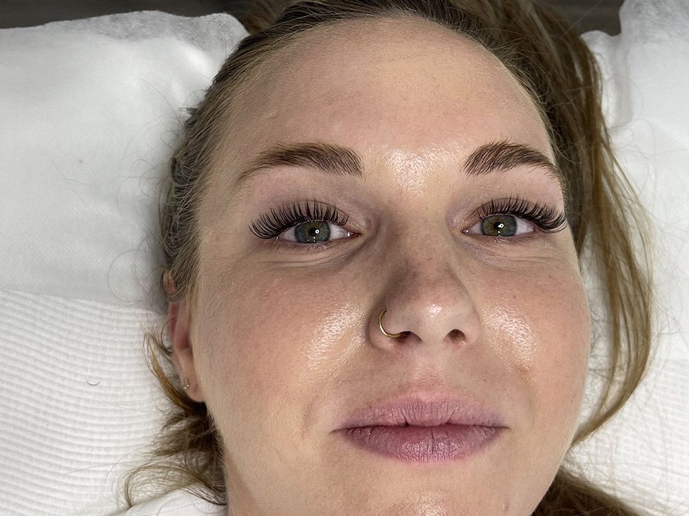 A Close up Of a Woman 's Face with A Nose Ring — Brow & Lash Clinic In Cairns