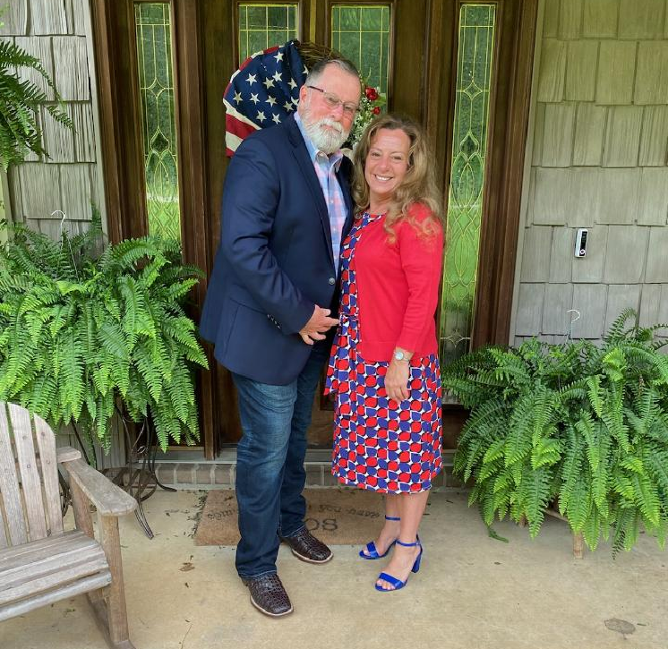 a man and a woman standing in front of a door