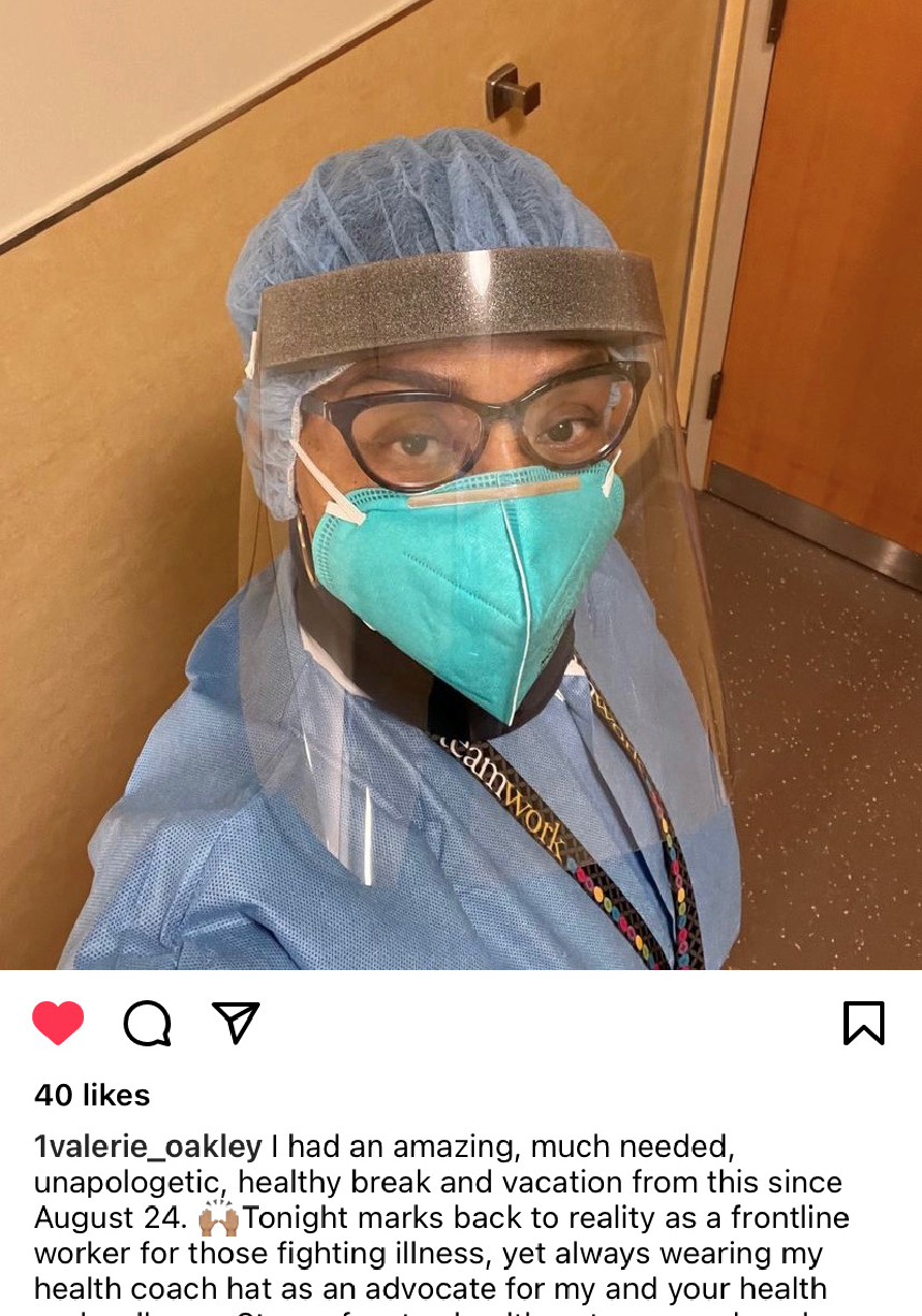 a nurse wearing a mask and a face shield is taking a selfie .