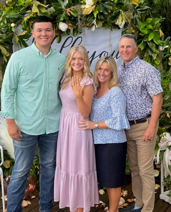 a group of people standing next to each other in front of a sign that says i love you .