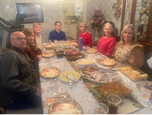 large family around a large table full of food