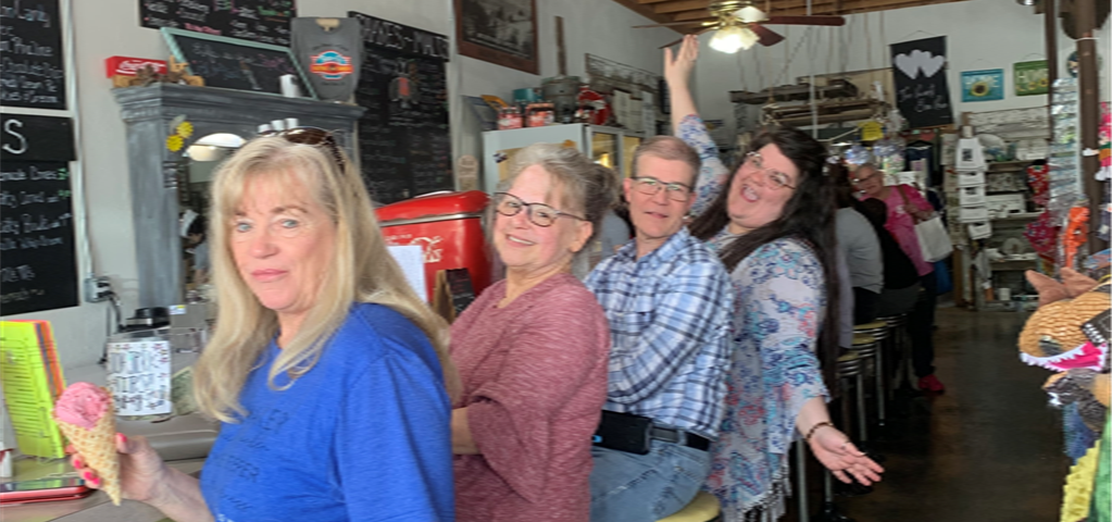 a group of people are posing for a picture in a restaurant .