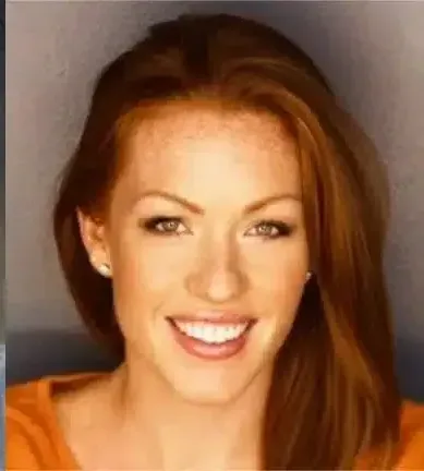 a woman with red hair and freckles is smiling for the camera .