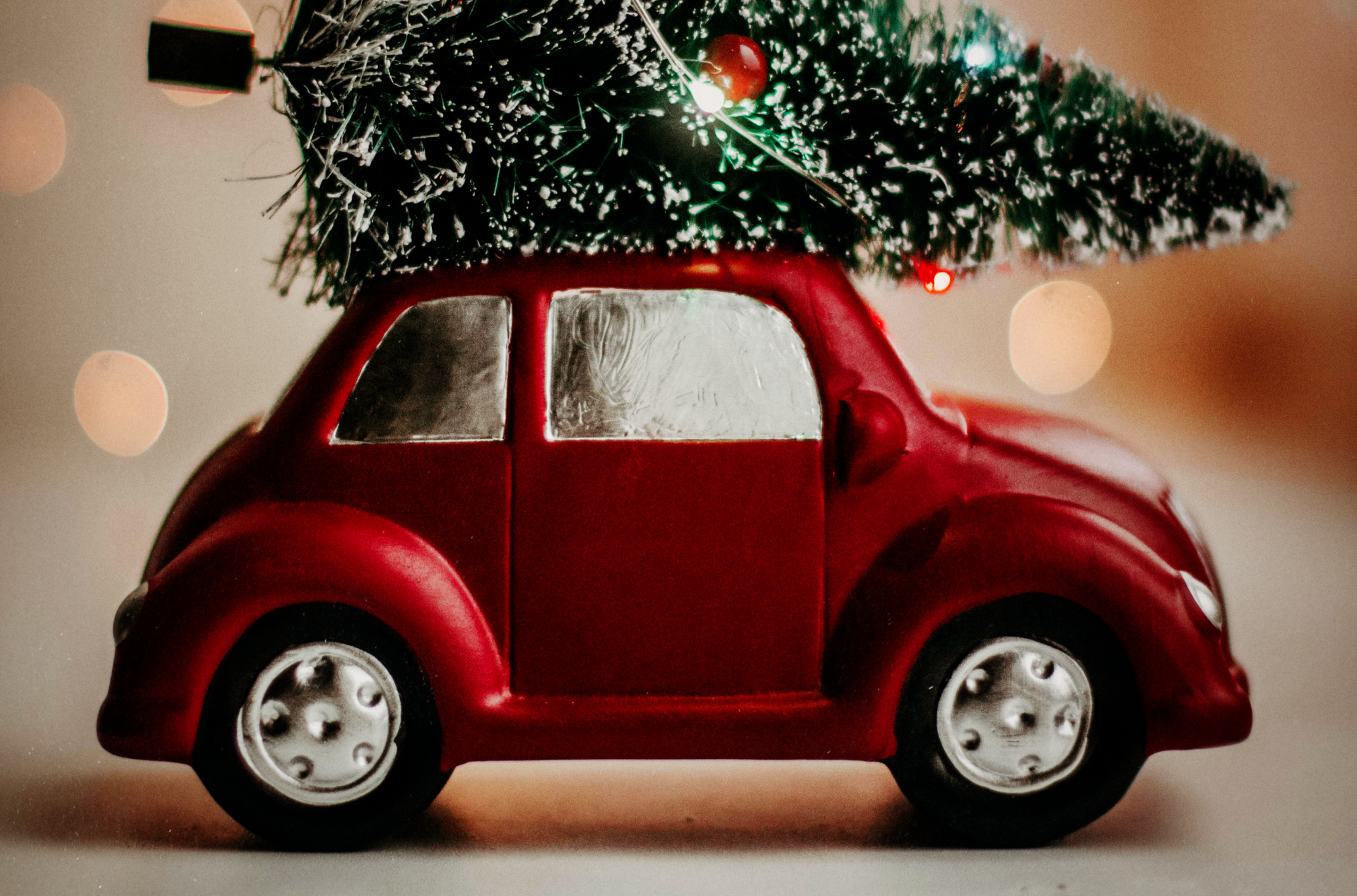 a toy car with a christmas tree on top of it .