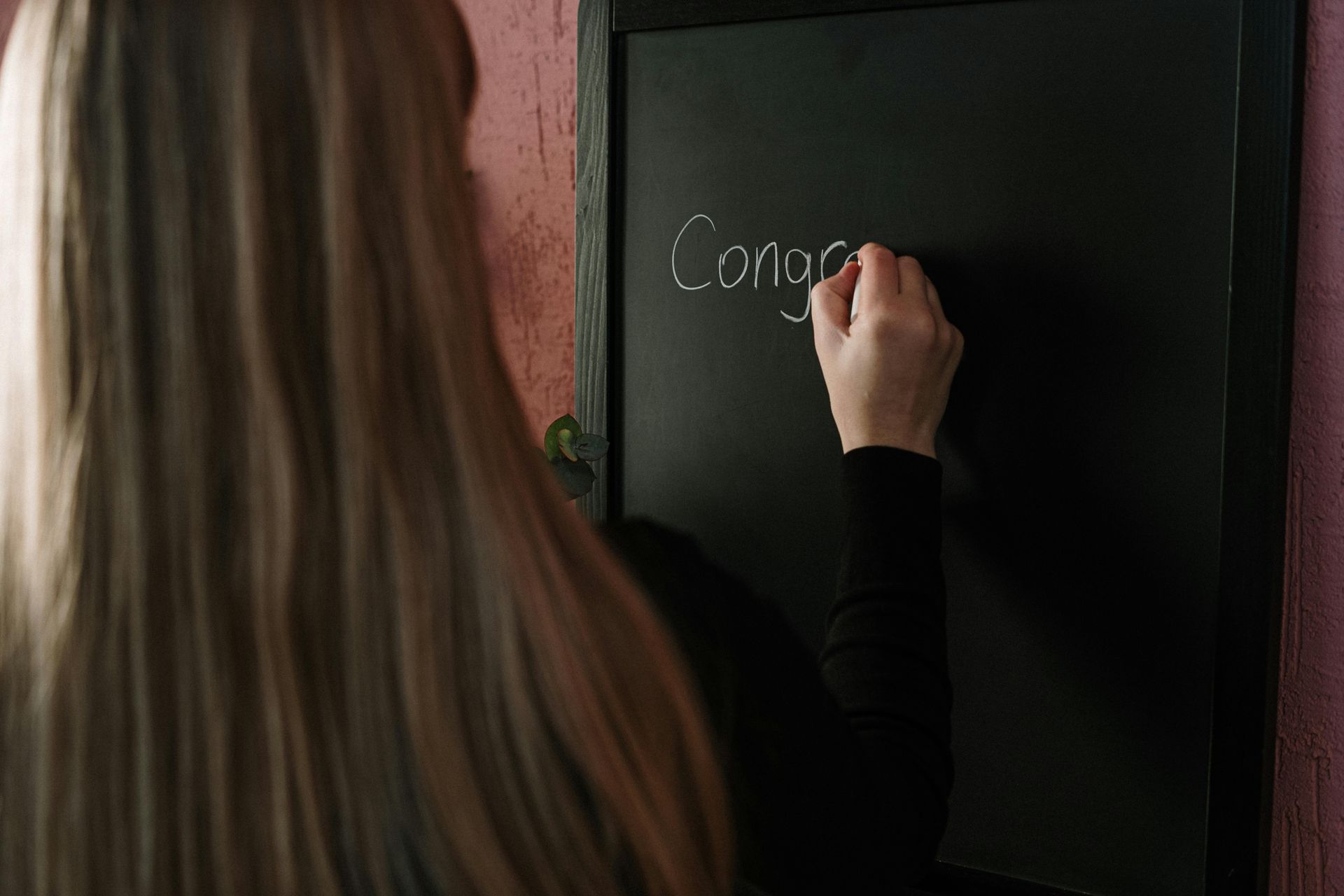 person writing on black board