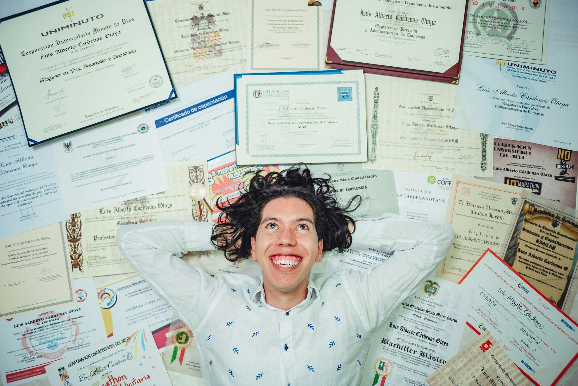 happy lady surrounded by certificates