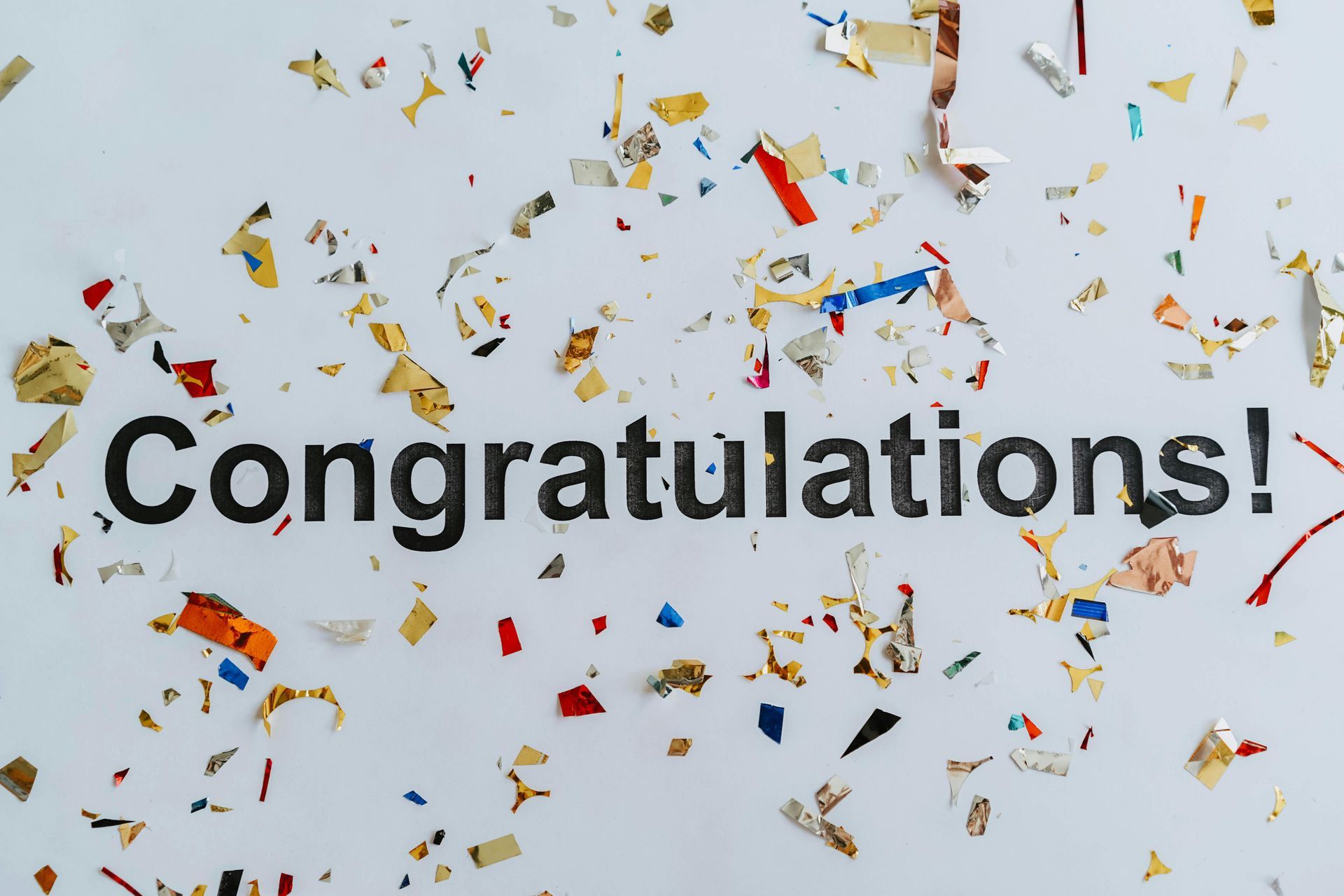 sign withCONGRATULATIONS and multi color confetti