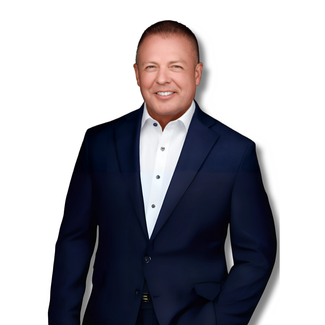 A man in a suit and white shirt is standing with his hands in his pockets.