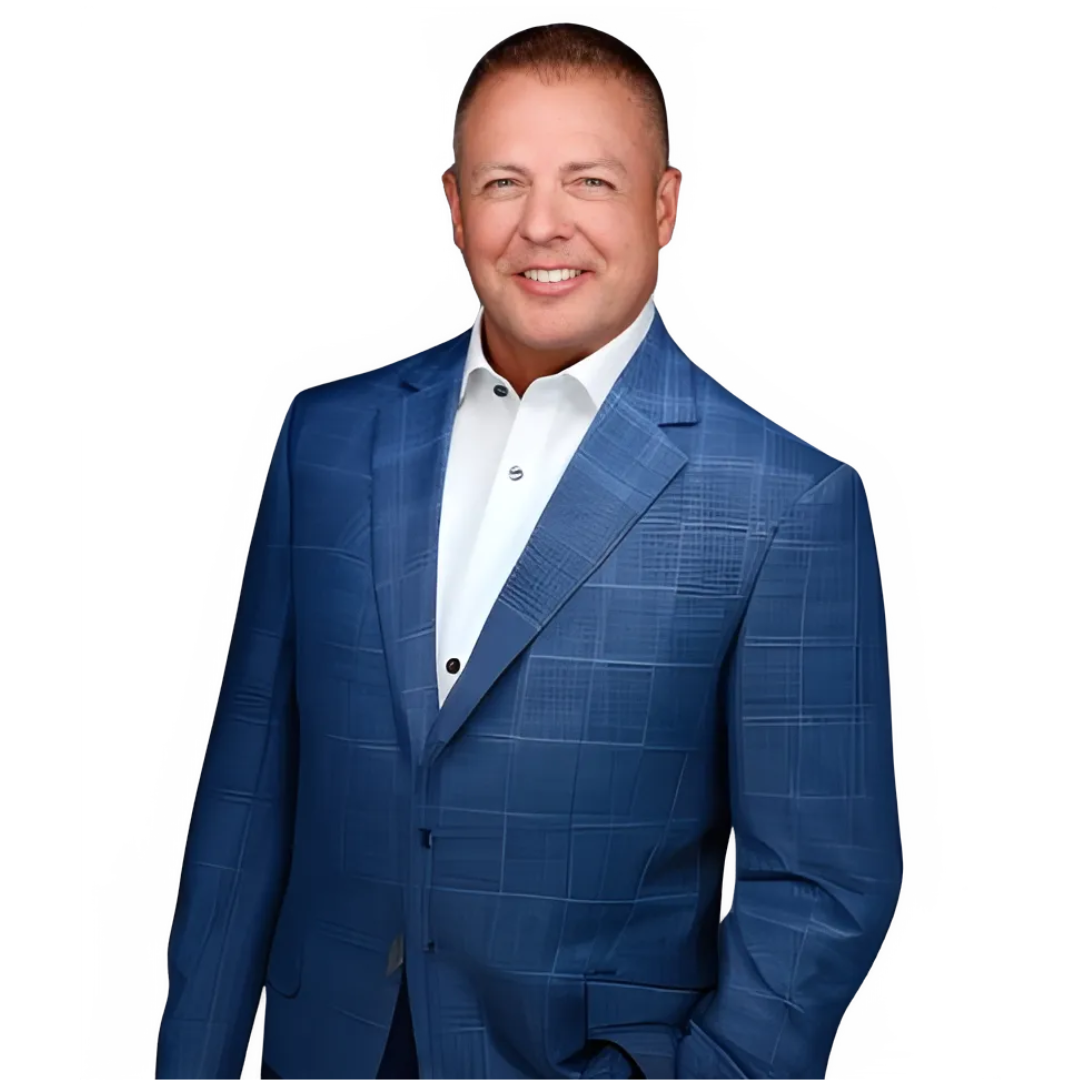 A man in a blue suit and white shirt is standing with his hands in his pockets.