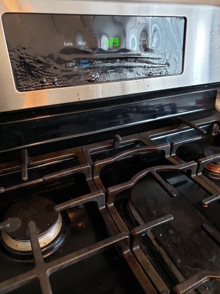 A close up of a stove top oven with the burners on.