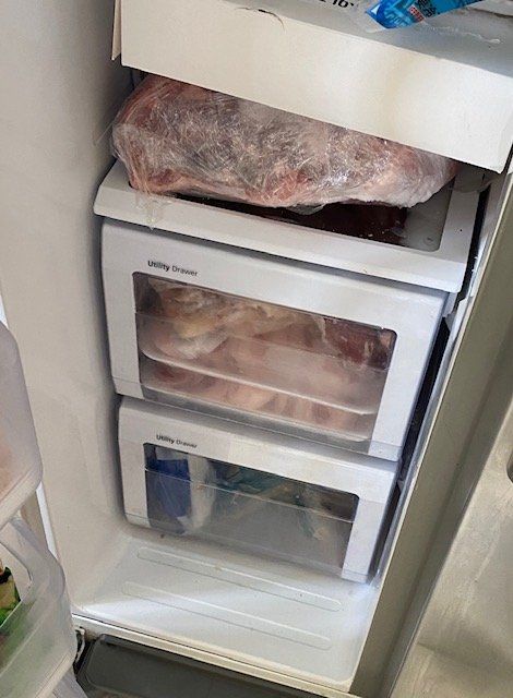 The inside of a refrigerator filled with lots of frozen food.