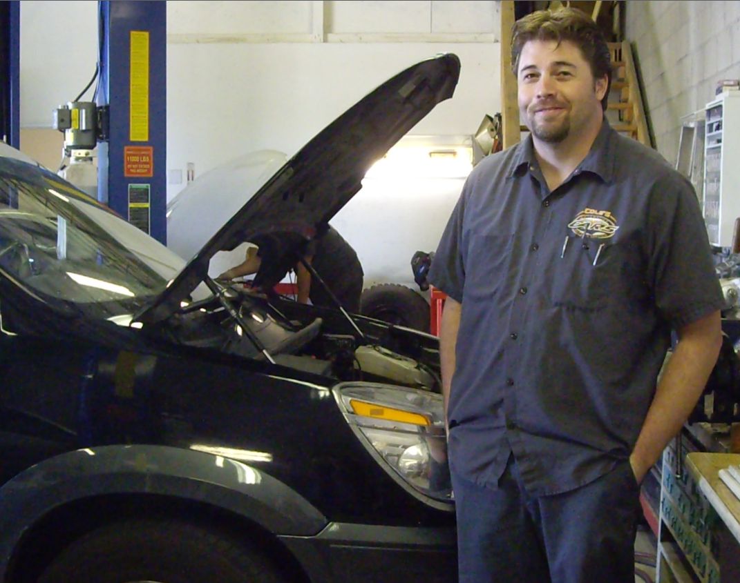 Mechanic Standing Beside Car With Open Hood | Cole's Auto Repair & Service
