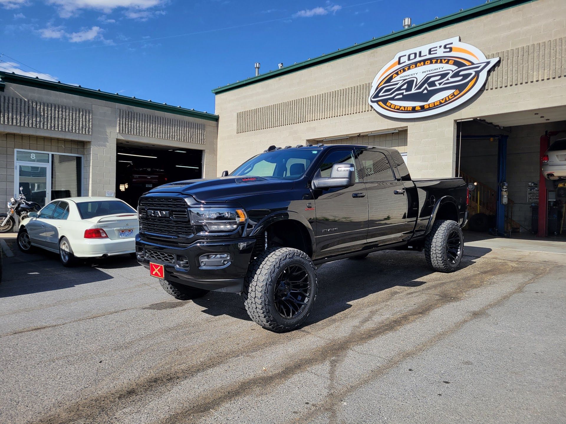 Black Truck Parked Outside Auto Shop | Cole's Auto Repair & Service