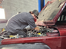 Brandon Working On Red Truck Engine | Cole's Auto Repair & Service