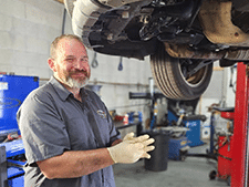 Doug Standing Under Vehicle Lift | Cole's Auto Repair & Service
