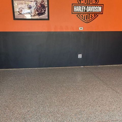 A harley davidson logo is on the wall of a garage