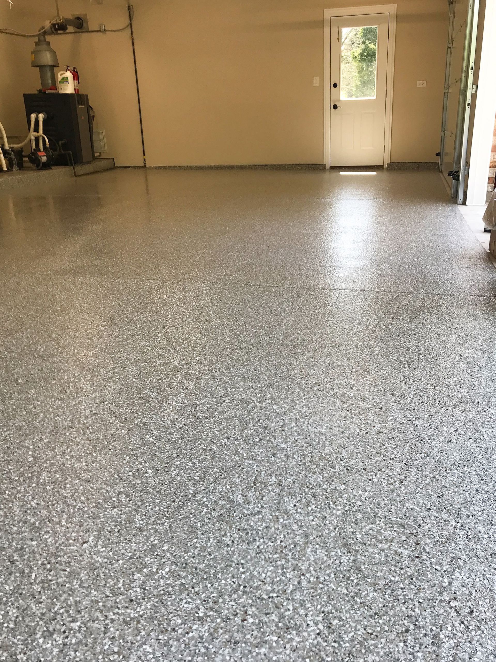 A garage with a gray floor and a white door