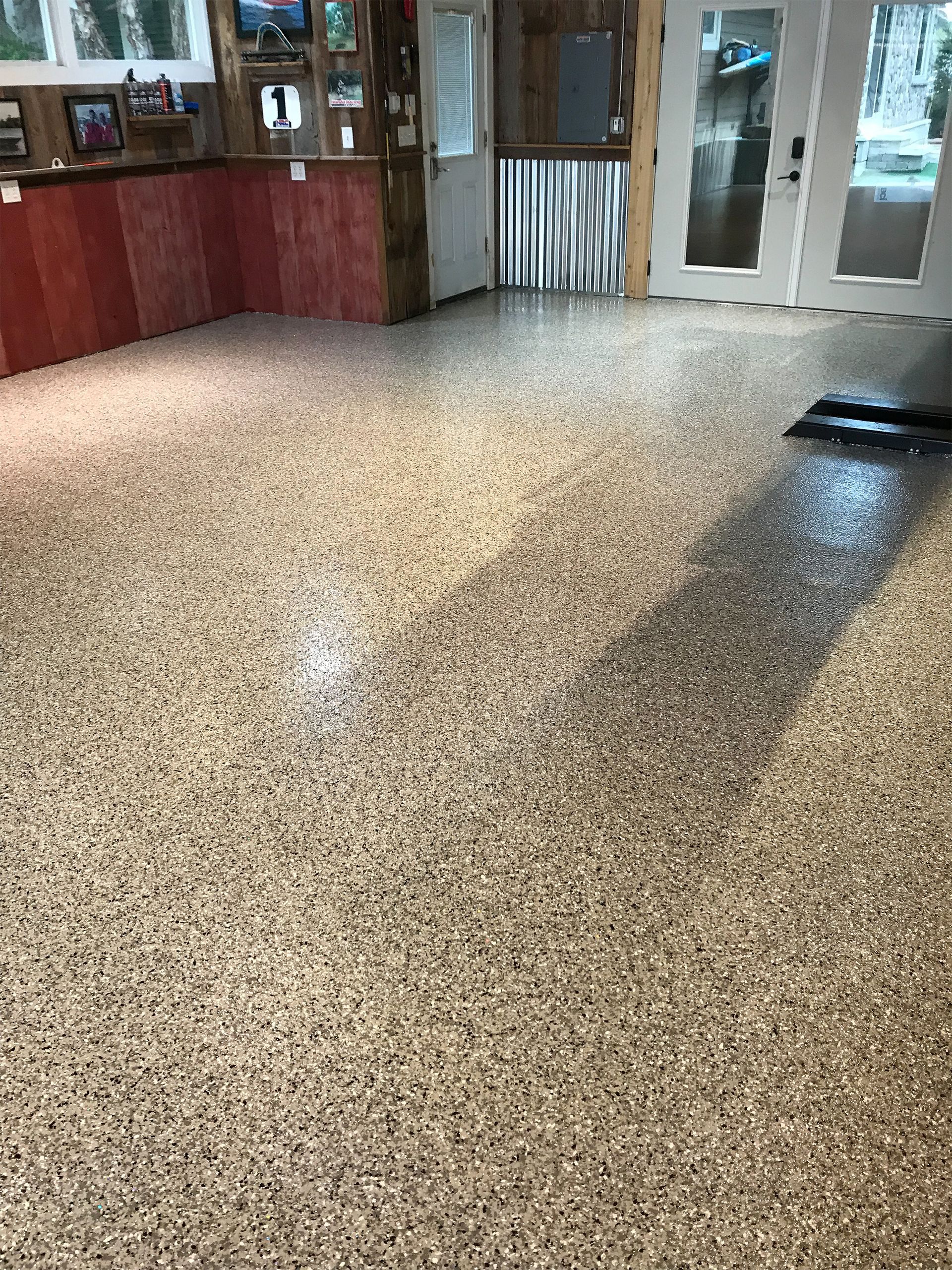 A room with a concrete floor and a red counter top.