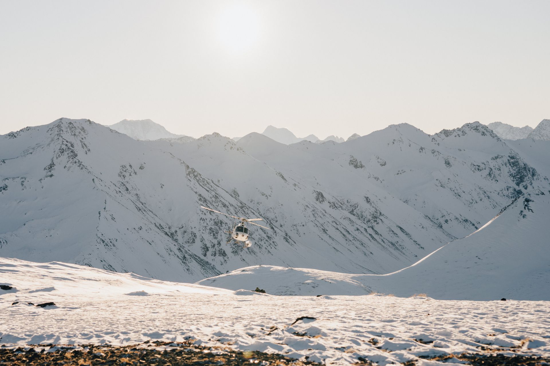 A person is skiing down a snow covered mountain.