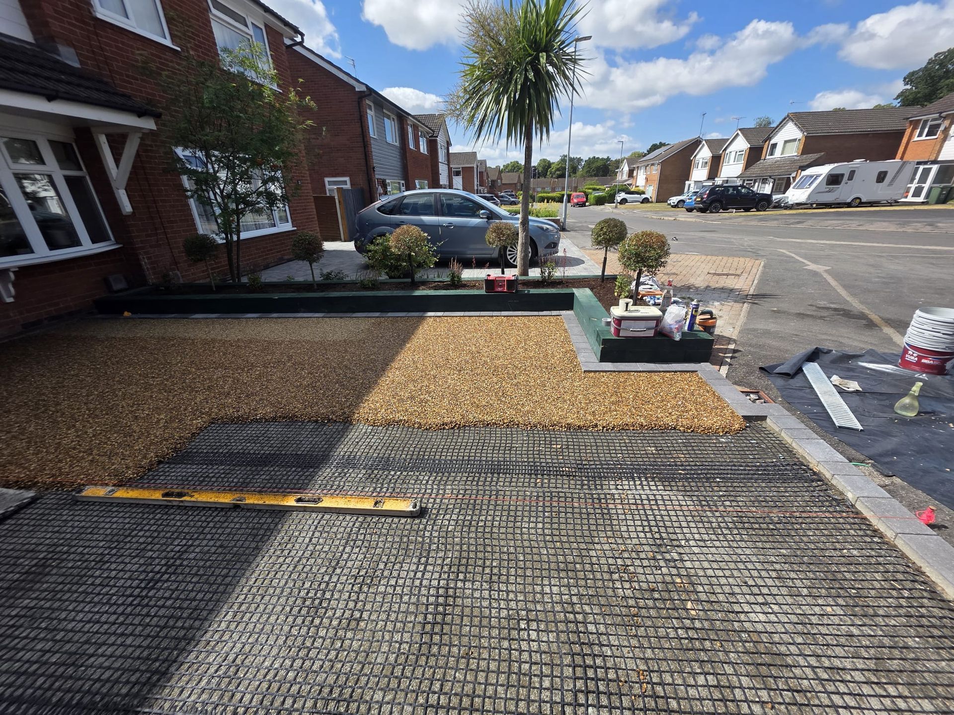 Driveway construction: gravel over plastic grid, level in place, residential setting 